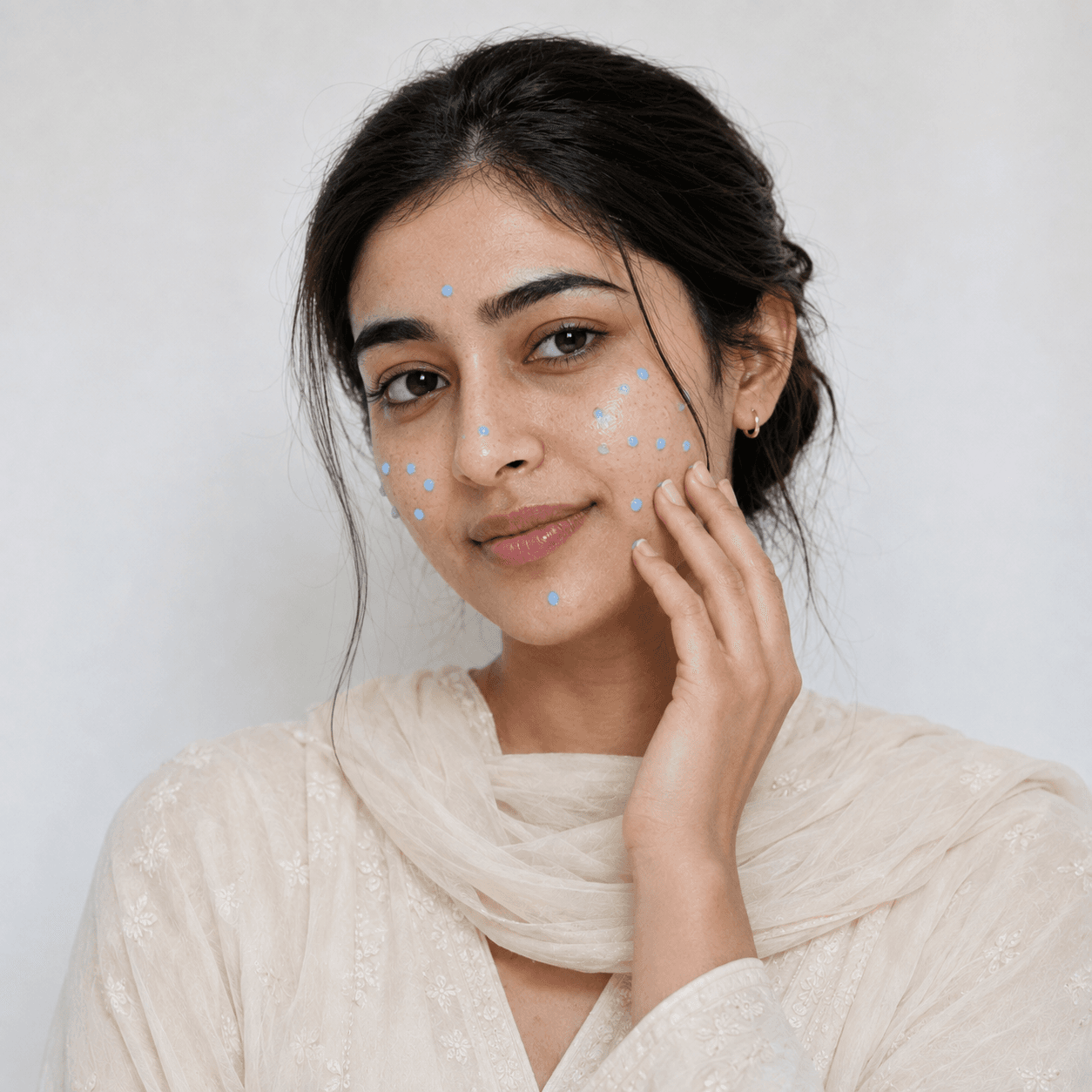 Duo Clay cream dots applied on the face before massage